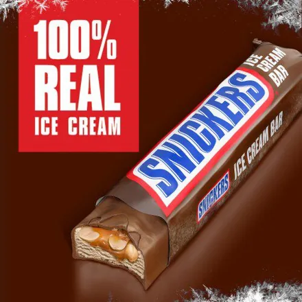 Snickers Ice Cream Bar showing caramel and peanuts through a cut section.